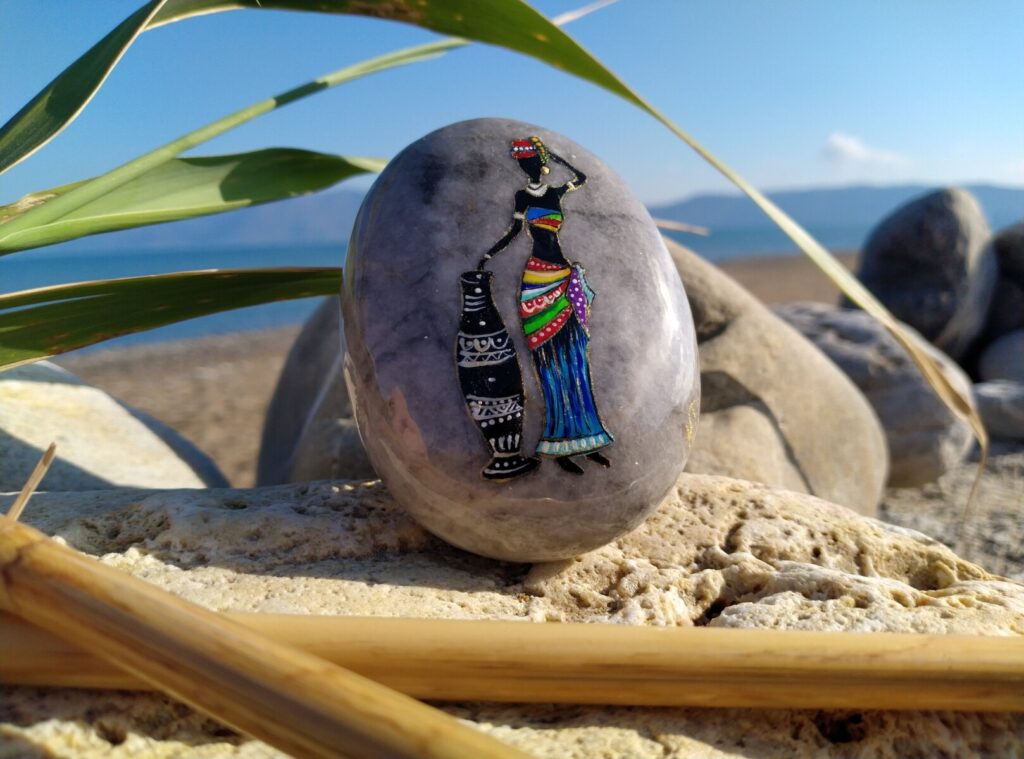 African lady painted on sea stone