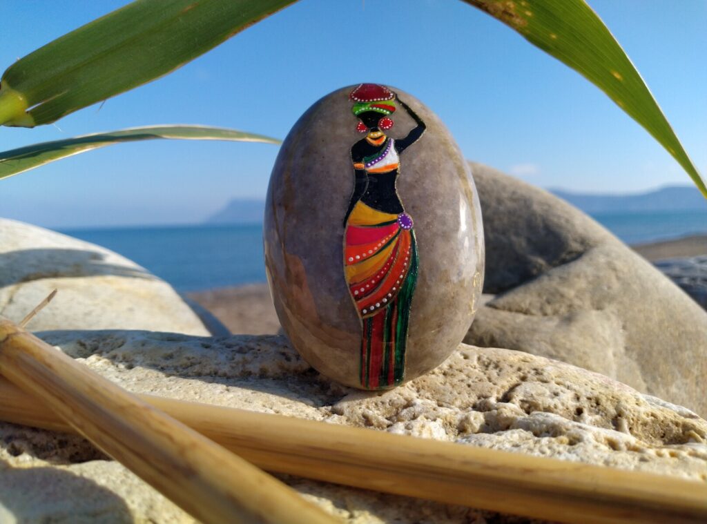 African lady painted on sea stone