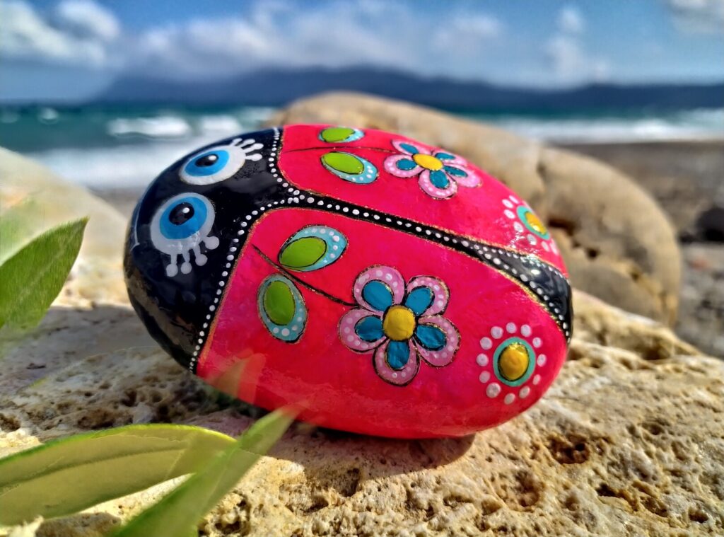 colorful ladybug painted on rock