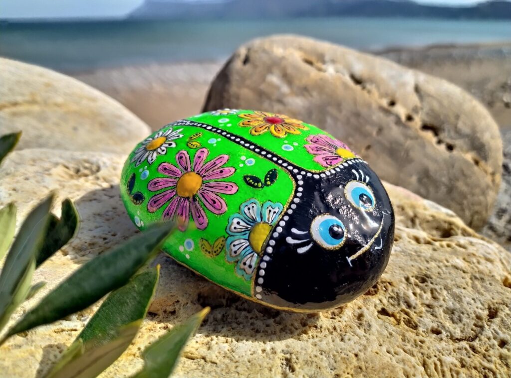 colorful ladybug painted on rock