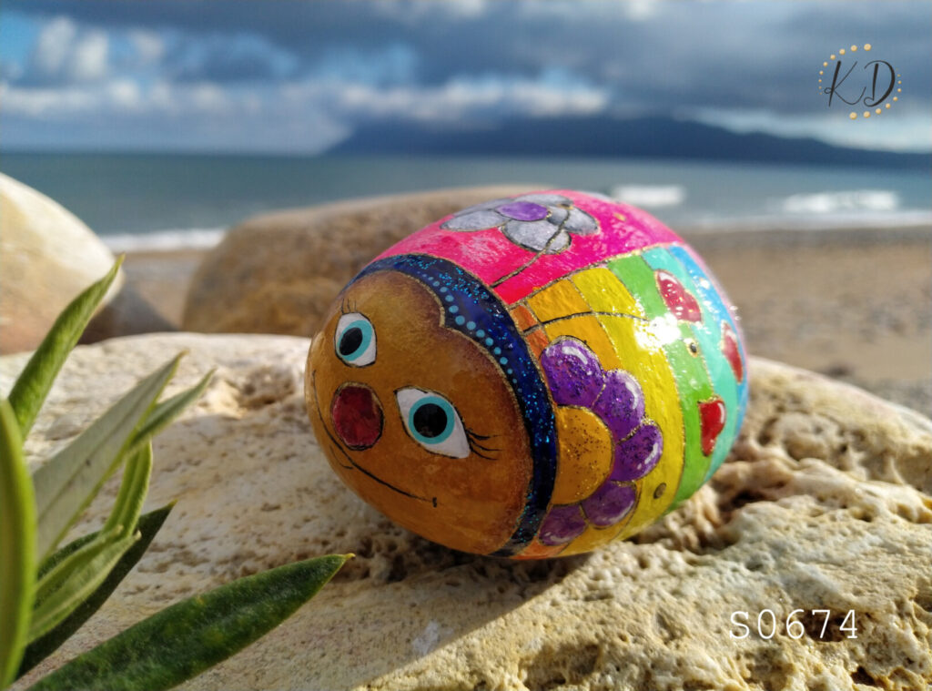 colorful ladybug painted on rock