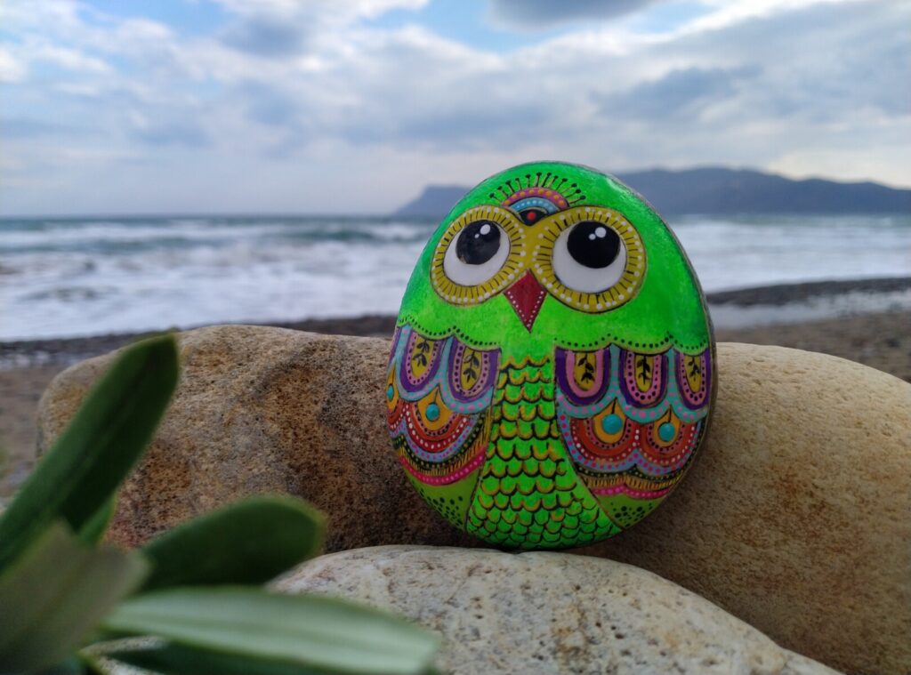 green owl painted on stone