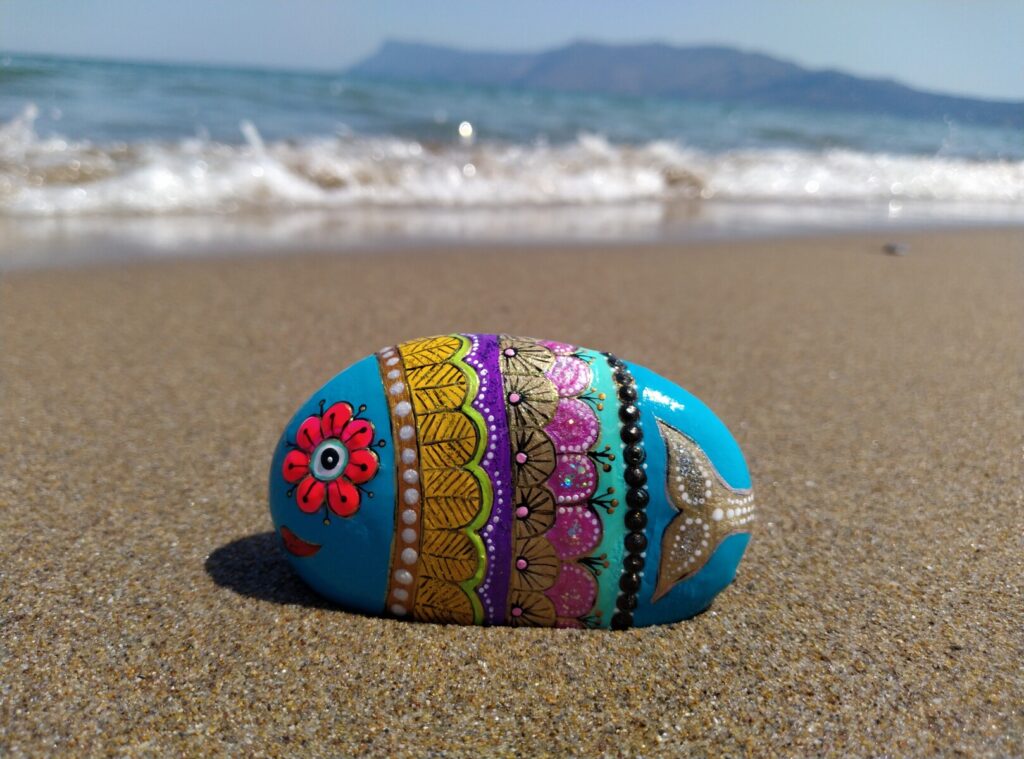 colorful fish paitned on stone by the beach