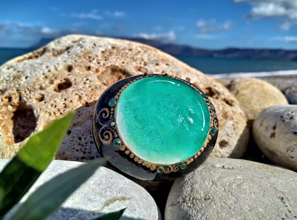Shiny jewel painted on stone near kissamos beach