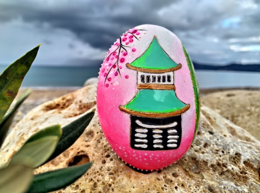 Japanese temple painted on stone placed by the sea