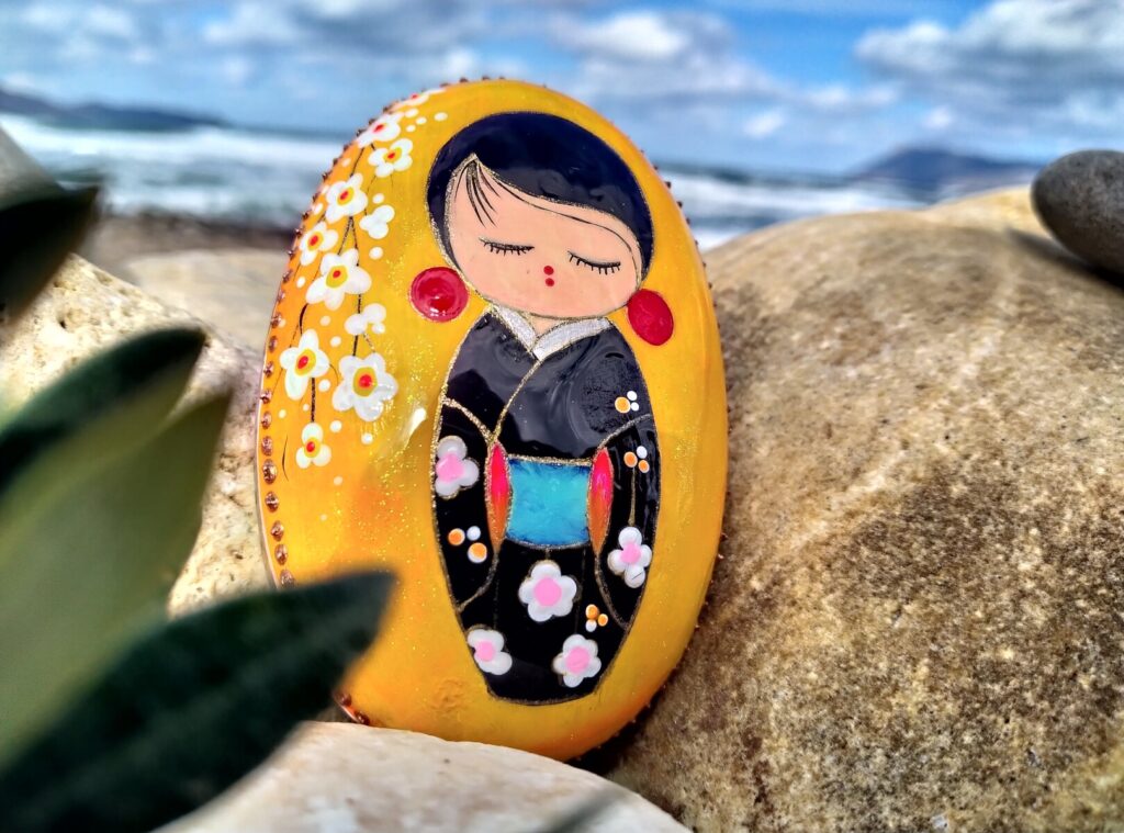 Kokeshi doll painted on stone
