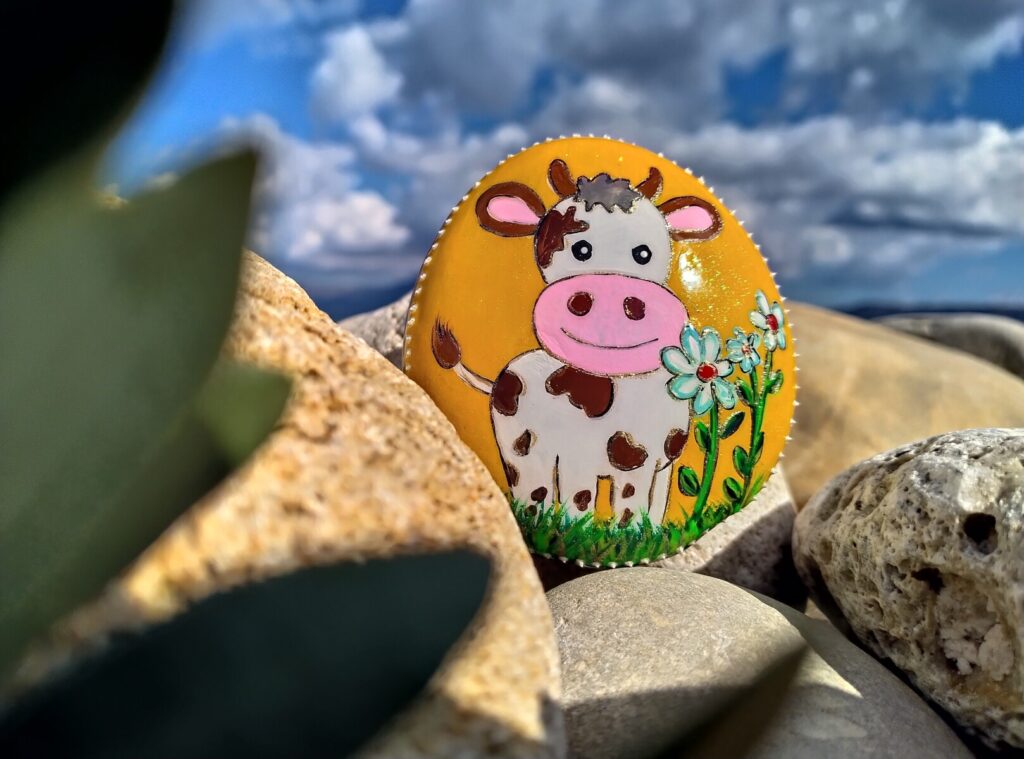 Hand paitned stone with cheerful little cow