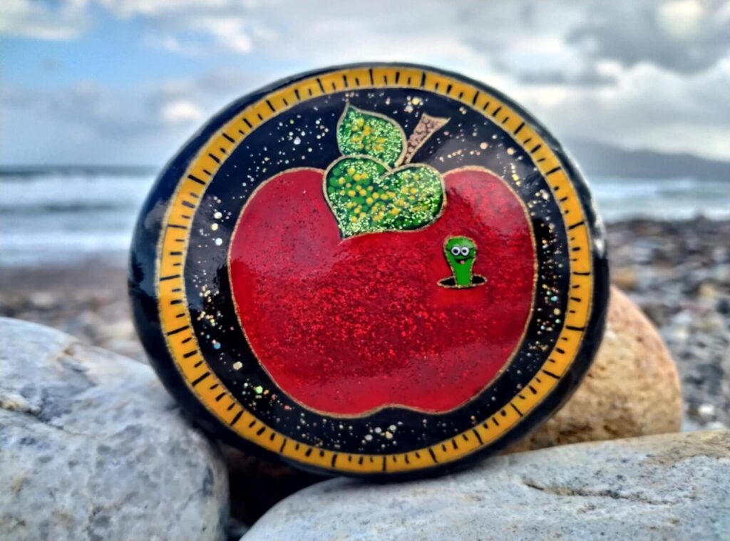 Hand made painted stone with apple and happy worm