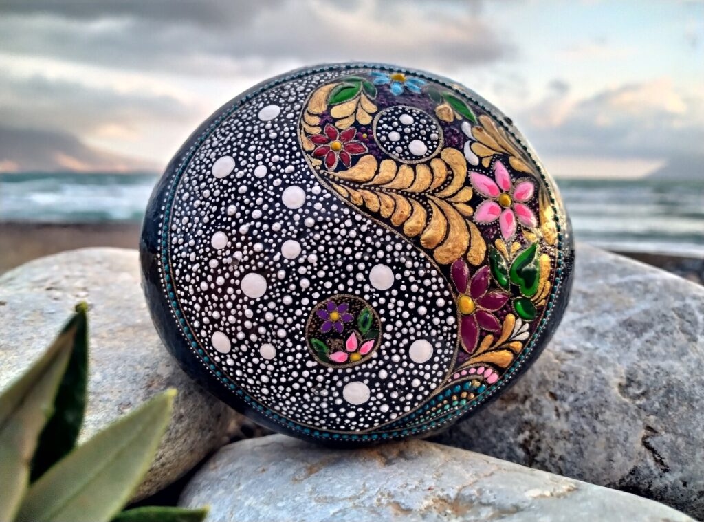 Black decorative hand painted stone with yin yang